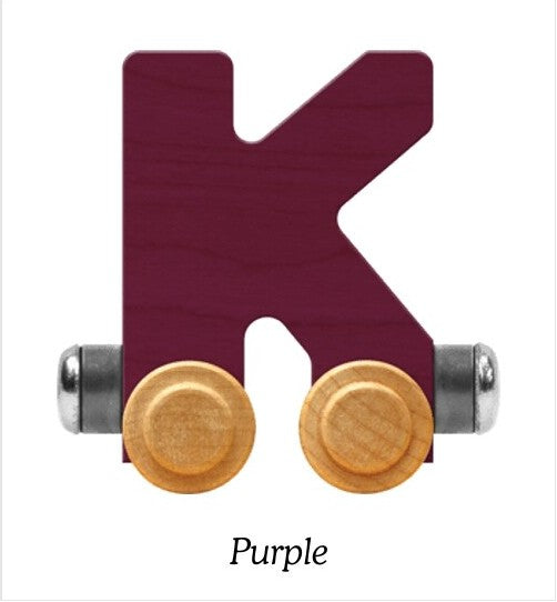 A wooden letter K toy train car in a deep purple color, featuring two light wood wheels and silver metal axles, shown on a white background with the word 'Purple' printed below.