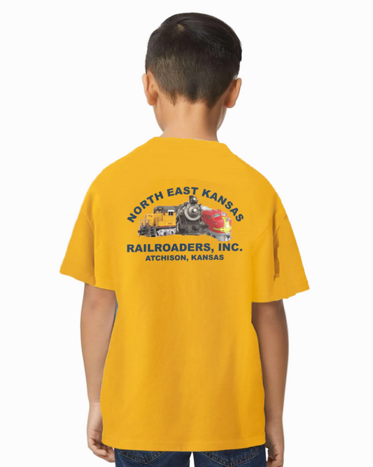 Child wearing a yellow t-shirt with 'North East Kansas Railroaders, Inc.' text and train graphic on a white background