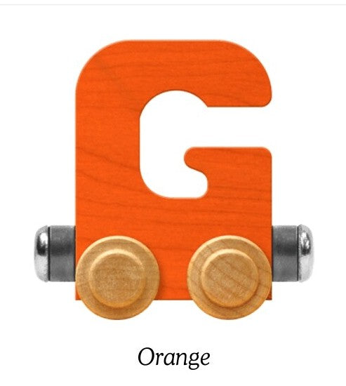 An orange wooden letter G toy train with natural wood wheels and silver metal accents, shown on a white background with the word 'Orange' underneath.
