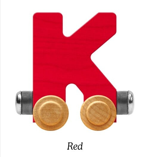 A wooden letter K toy in bright red, with two round natural wood wheels and silver metal axles, shown on a white background with the text 'Red' below.